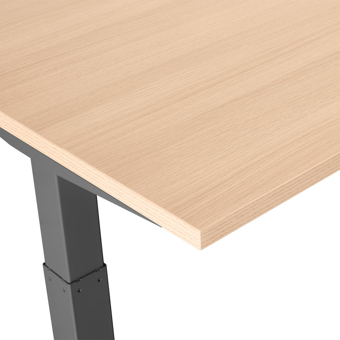 Close-up of a modern adjustable standing desk with a wooden top and metal legs. (Natural Oak-57&quot;)(Natural Oak-47&quot;)(Natural Oak-60&quot;)