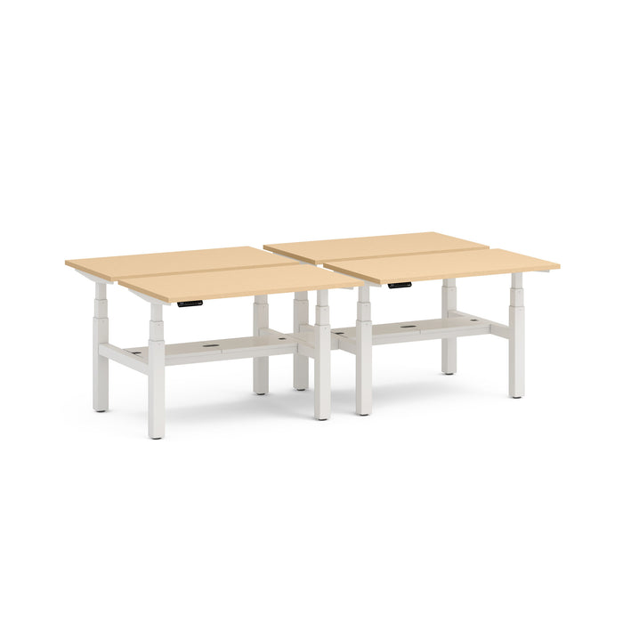 Two modern height-adjustable beige desks with white frames on a white background. (Natural Oak-47&quot;)
