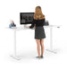 Woman working at standing desk with computer and office supplies. (White-72&quot;)