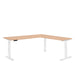 L-shaped modern office desk with wooden tabletop and white legs on a white background. (Natural Oak)