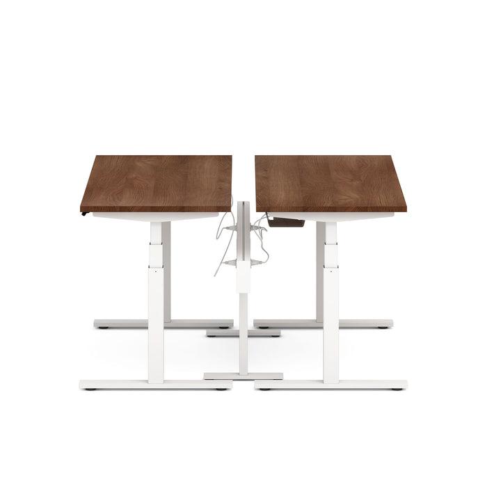 Dual motor standing desk with brown tabletop and white frame on a white background. (Walnut-57&quot;)