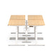 Dual sit-stand workstations with wooden tabletops and white frames against a white background. (Natural Oak-47&quot;)