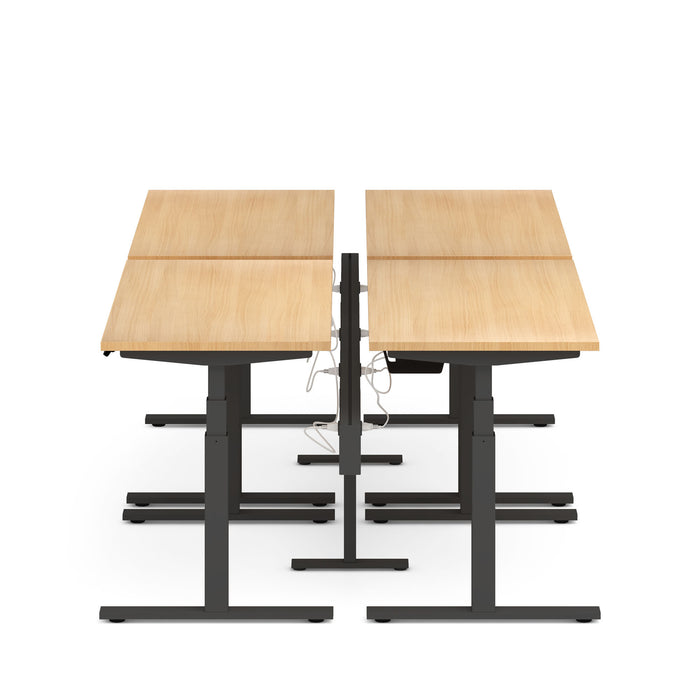 Dual sit-stand desks with wooden tabletops and black frames on a white background. (Natural Oak-57&quot;)