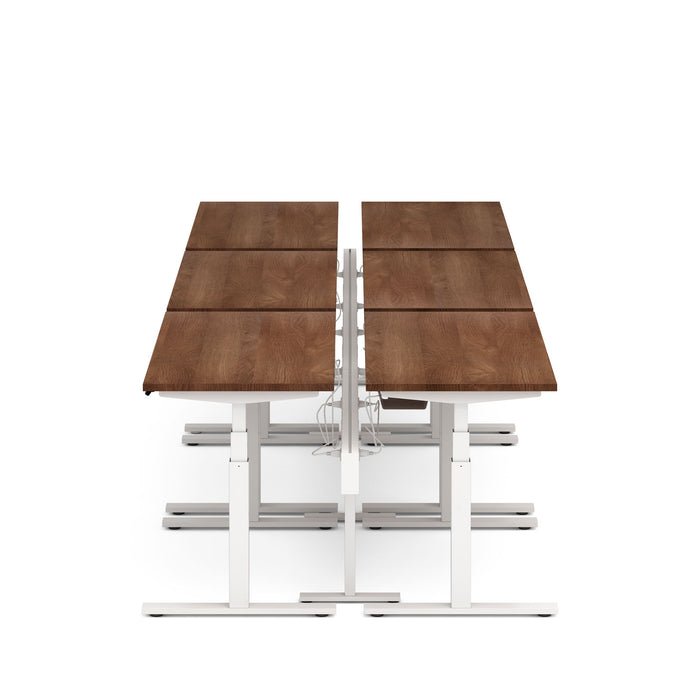 Modern height-adjustable desk with brown tabletop and white frame on a white background. (Walnut-57&quot;)