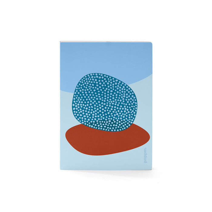 Abstract blue notebook with dotted circle design on cover against white background. (Sky)