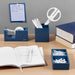 Organized desk with stationery, notebooks, and clipboard on a wooden table. (Slate Blue)