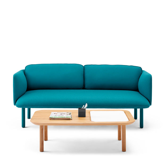 Modern teal sofa with wooden legs and a small coffee table with books and pens on a white background. (Teal)