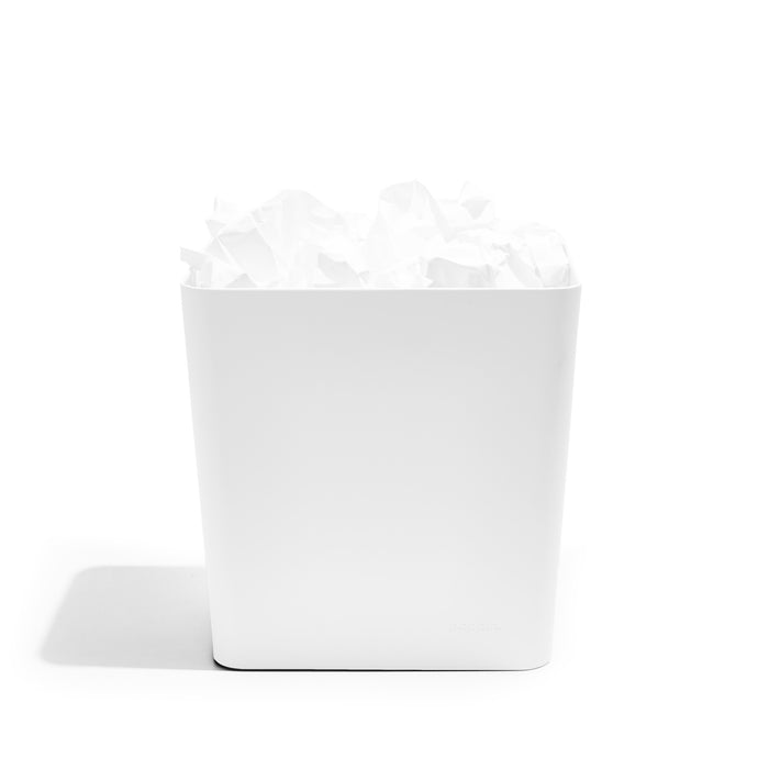 White trash bin with crumpled paper inside on a white background. (White)