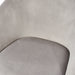 Close-up of a modern grey velvet chair with a curved backrest. (Gray)