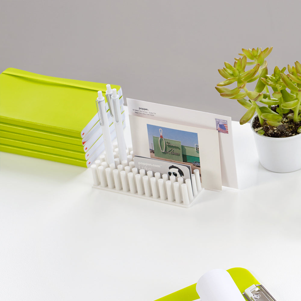 White desk organizer with business cards and a pen on a clean background. (White)
