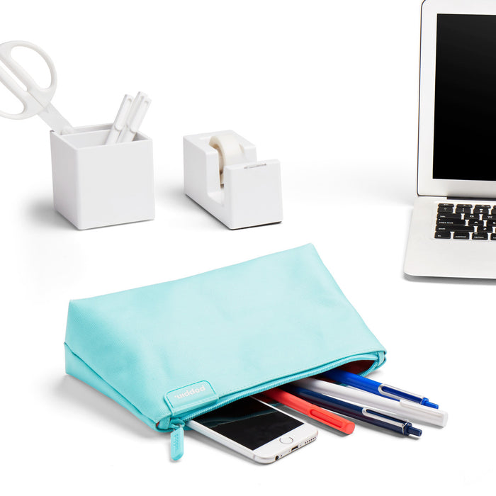 Modern desk with laptop, smartphone, stationery, and blue pouch on white background. (Aqua)