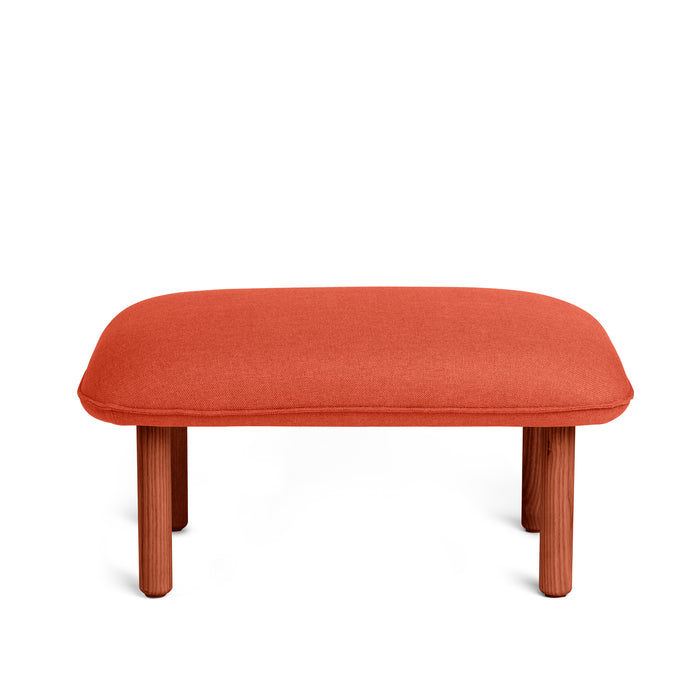 Modern red fabric upholstered ottoman on white background. (Brick)
