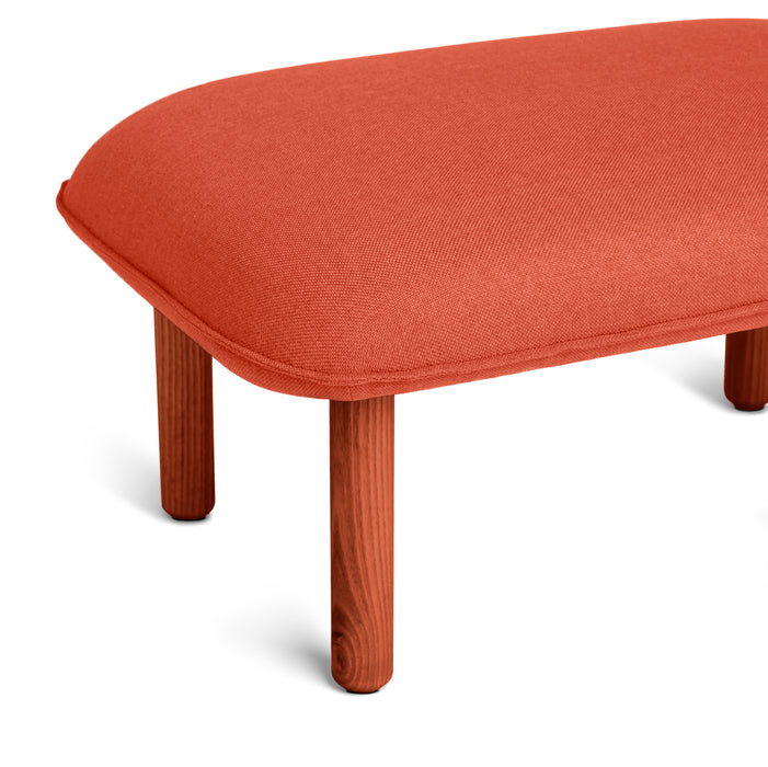 Modern red fabric ottoman with wooden legs on white background (Brick)