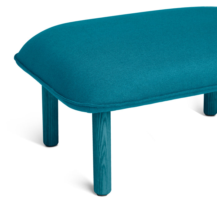 Modern turquoise ottoman with wooden legs on white background (Teal)