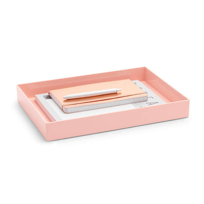 Pink desk tray with white papers and a beige notebook on a white background. (Blush)