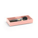 Pink makeup brush holder with black brushes on white background. (Blush)