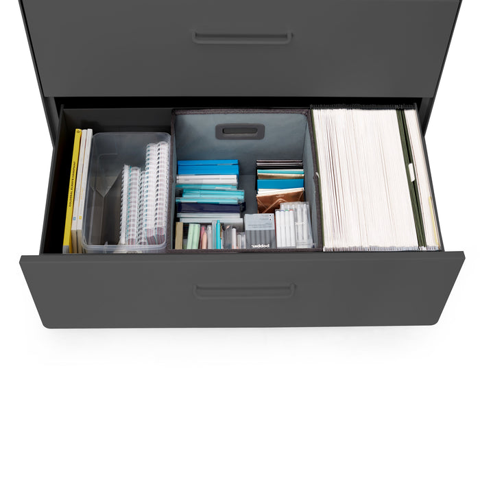 Open drawer with organized office supplies and documents. (Charcoal)