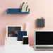 Organized desk with laptop, smartphone, and stationery against a pink wall. (Dark Gray)
