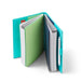Turquoise notebook with elastic closure open on white background (Aqua)(Blush)