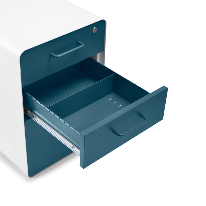 "Modern teal file cabinet with one open drawer on a white background." (Slate Blue-White)