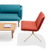 Modern living room furniture with teal sofa, red chair, and wooden coffee table. (Brick-Brass)