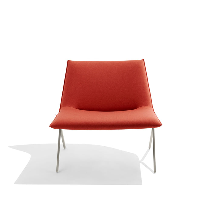 Modern red fabric lounge chair with sleek metal legs on white background. (Brick-Nickel)