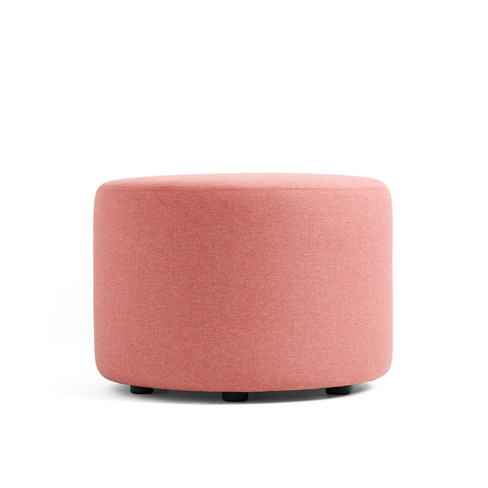 Round pink fabric ottoman on a white background. (Rose)
