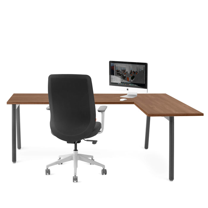Modern office desk with a black ergonomic chair and computer setup on white background. (Walnut)