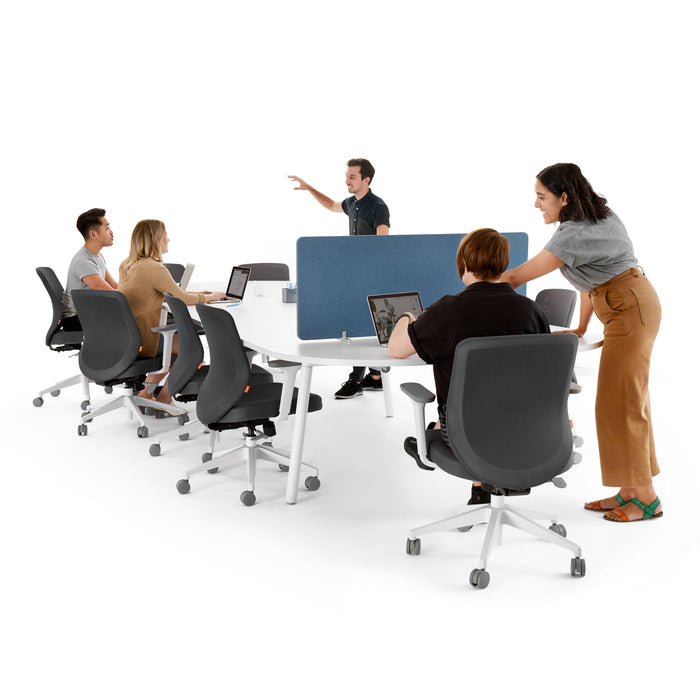 Team meeting in modern office with one person presenting and others at laptops. (White-180&quot;)