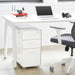 Modern home office setup with white desk, laptop, and ergonomic chair. (Black)(White)(Light Gray)