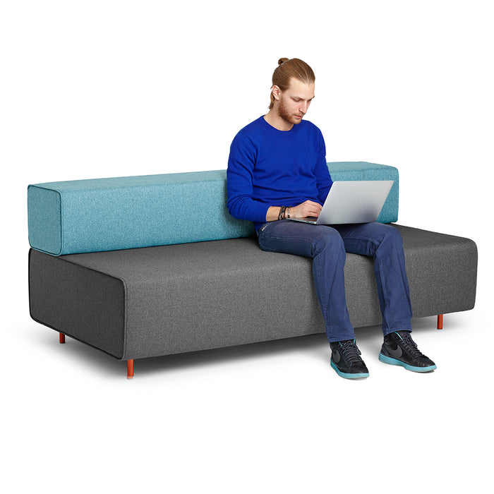 Man working on laptop sitting on modern two-tone sofa. (Dark Gray-Blue)