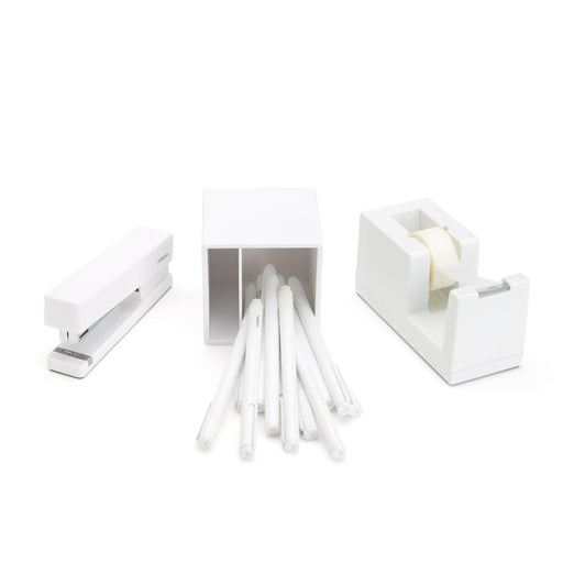 Office supplies including a stapler, pens, tape dispenser, and a pen holder on a white background. (White)