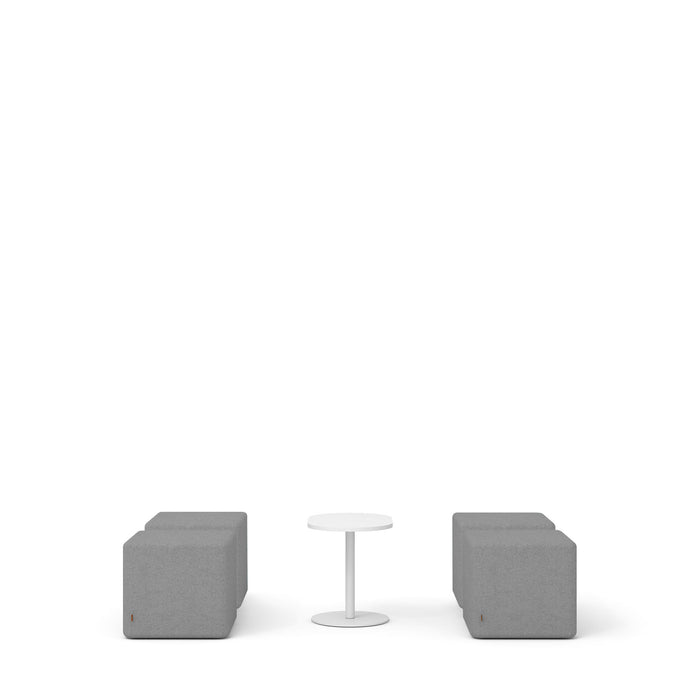Modern minimalist furniture setup with two grey cube chairs and a small round white table on a white background. (Gray)