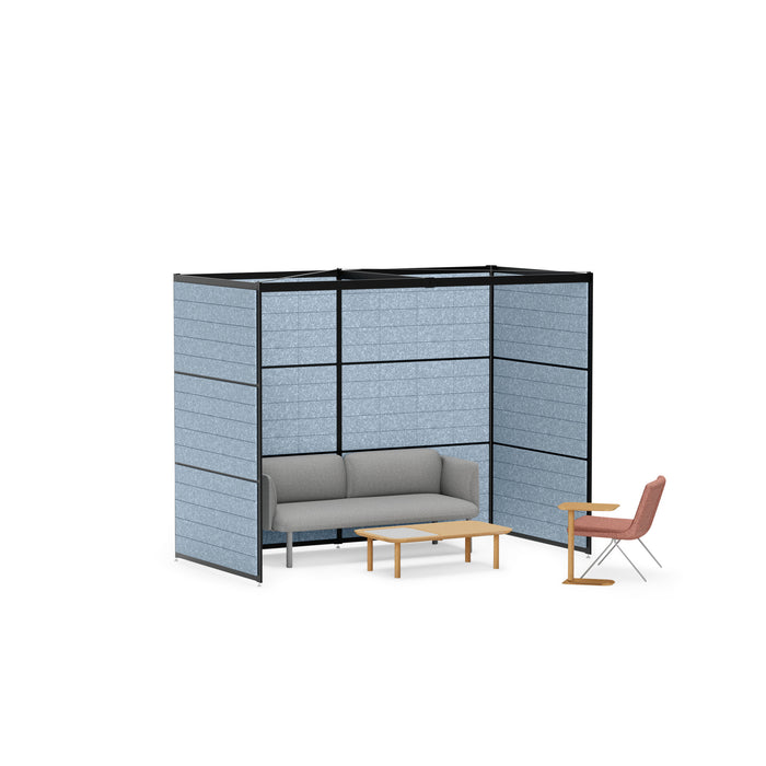 Modern office lounge area with gray couch, wooden table, and divider panels on a white background. (Black-Private-Blue Panel)