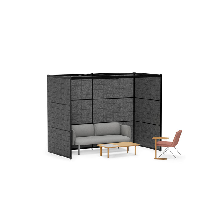 Modern office lounge area with gray sofa, privacy panels, wood tables, and pink chair (Black-Private-Black Panel)