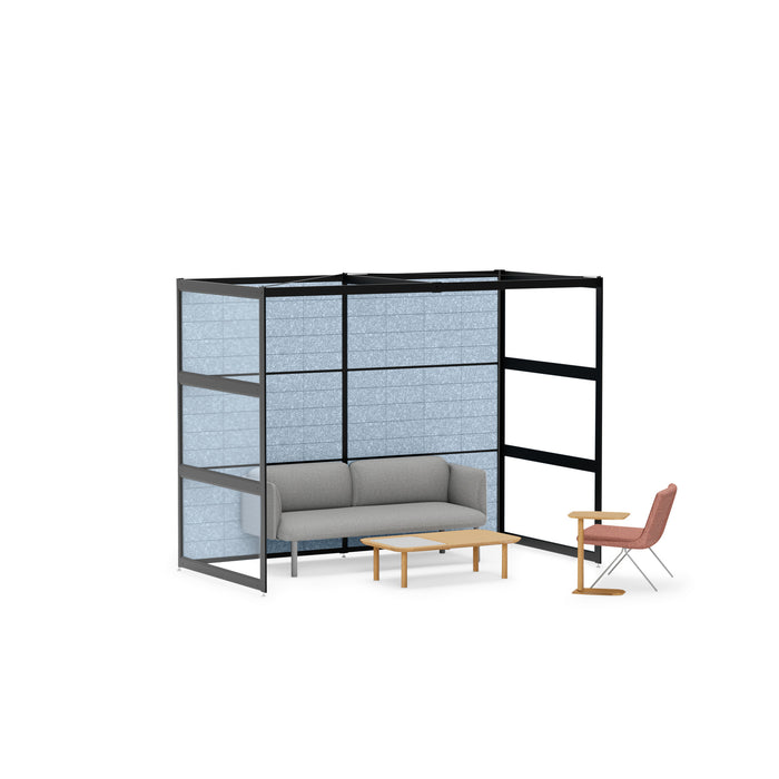 Modern office nook with black shelving unit, gray couch, small wood table, and chair on a white background. (Black-Semi-Private-Blue Panel)