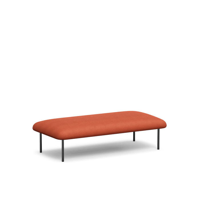 Modern red fabric bench with black metal legs on a white background. (Brick)