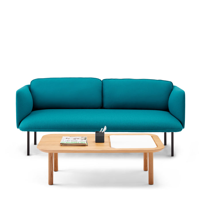 Modern teal sofa with wooden coffee table and books on white background 
