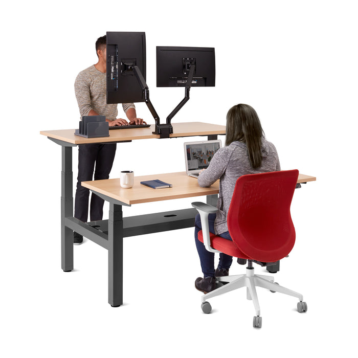 Two professionals working at a modern standing desk with dual monitors and ergonomic chairs. (Natural Oak-57&quot;)