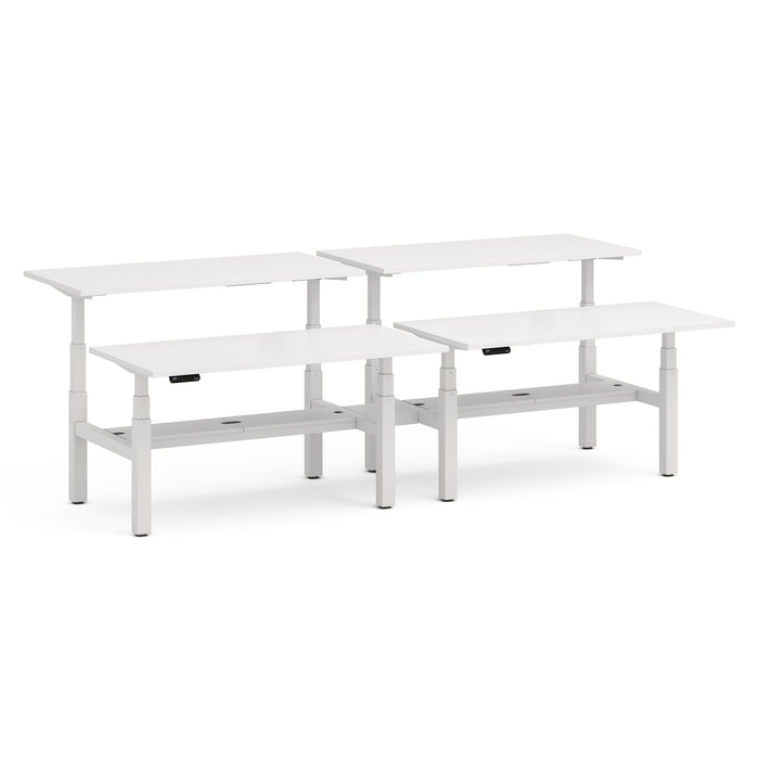 White adjustable height standing desks with cable management trays on a white background. (White-60&quot;)