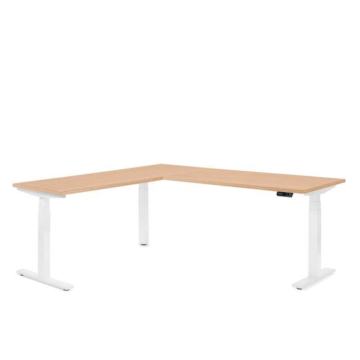 L-shaped electric adjustable height desk with wooden top and white legs. (Natural Oak)