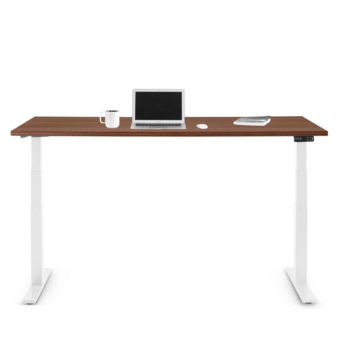 Modern standing desk with laptop, smartphone, and coffee cup on white background. (Walnut-72&quot;)