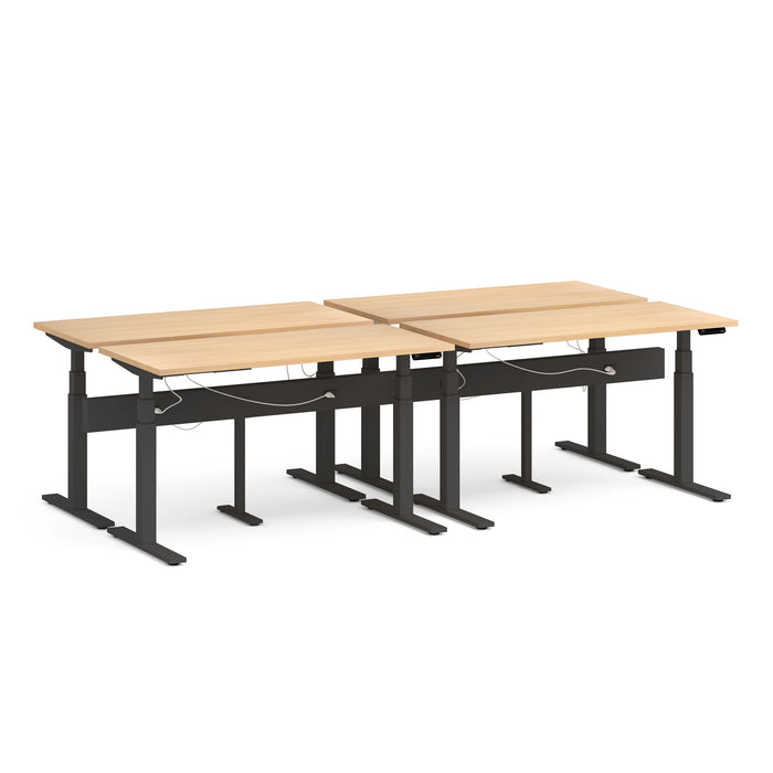 Adjustable height desks with wooden tabletop and black frame in an office setting. (Natural Oak-57&quot;)