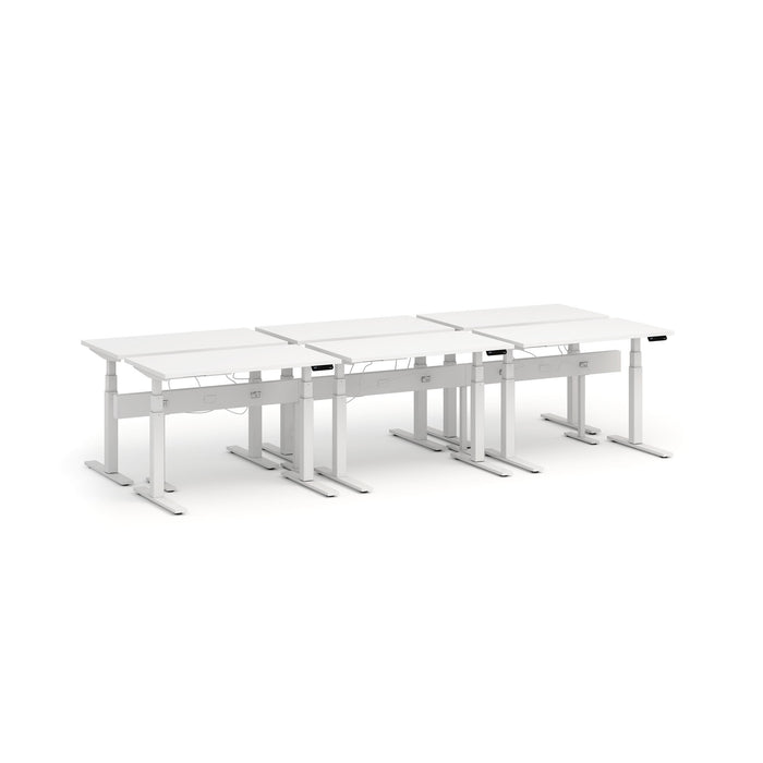 Modern white height-adjustable office desks arranged in a row on a white background. (White-47&quot;)