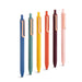Colorful assortment of pens standing vertically on a white background. 
