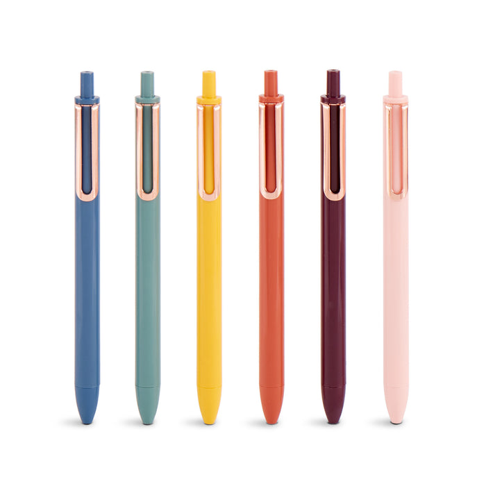 Colorful retractable pens lined up on a white background. 