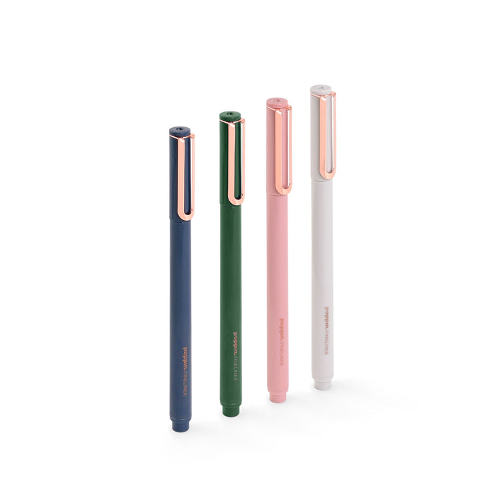 Four stylish pens in navy, green, pink, and white colors standing upright on (Velvet)