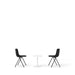 Two black modern chairs facing each other with a small white table in the middle on a white background. (Black)