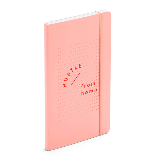 Peach-colored notebook with "Hustle from home" text standing on white background. 