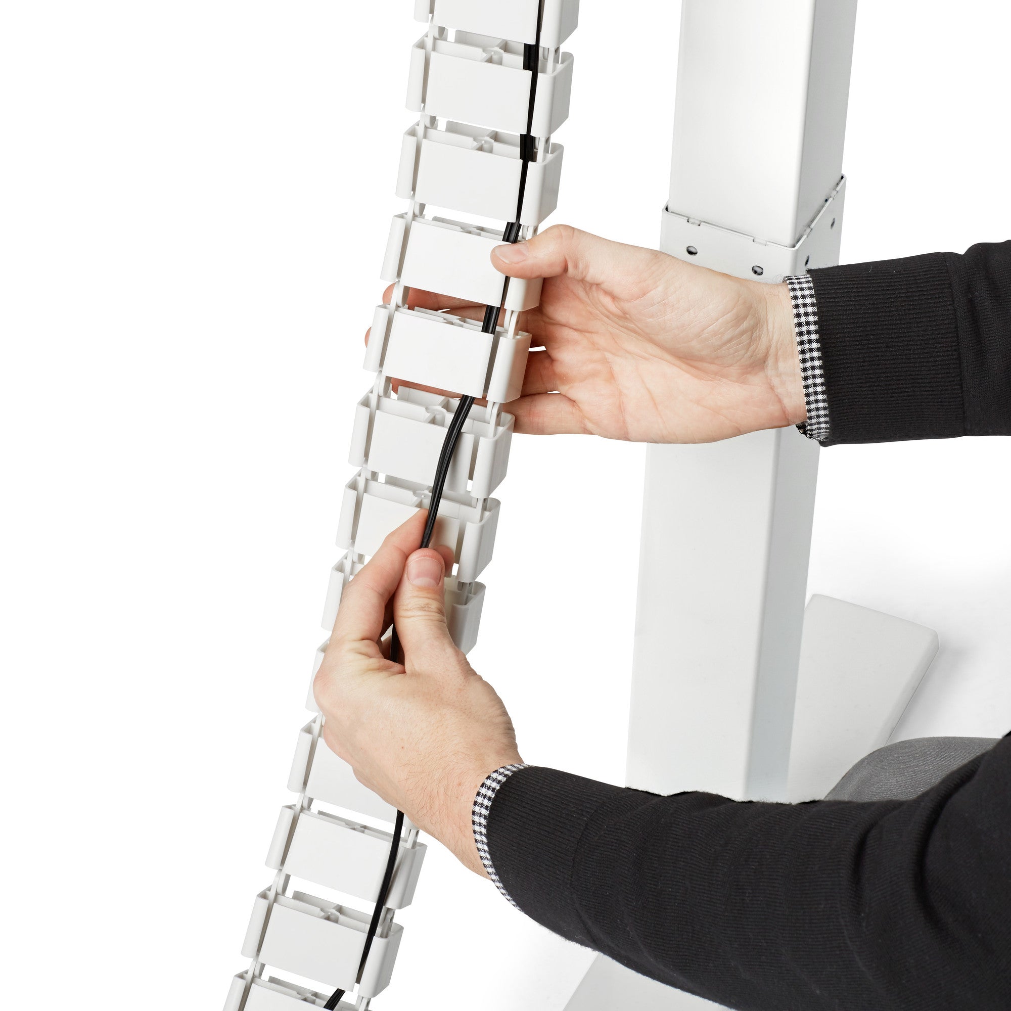 White standing desk with cable management spine on a clean background. 